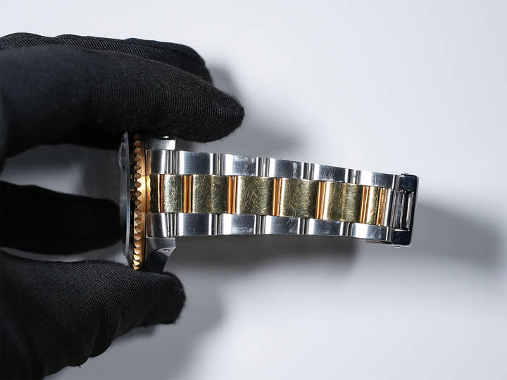 Pre-owned Rolex GMT-Master II Ref. 16713 in stainless steel/yellow gold with a black dial and Oyster bracelet (ygieugp7)