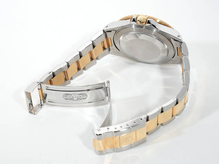 Pre-owned Rolex GMT-Master II Ref. 16713 in stainless steel/yellow gold with a black dial and Oyster bracelet (anvkf7ce)